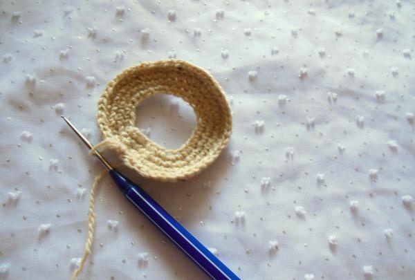 Crochet pincushion in the shape of a donut