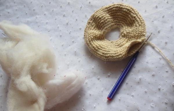 Crochet pincushion in the shape of a donut