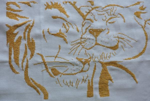 Embroidering a pair of golden lions