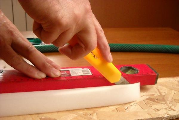 Cut out a strip of foam rubber