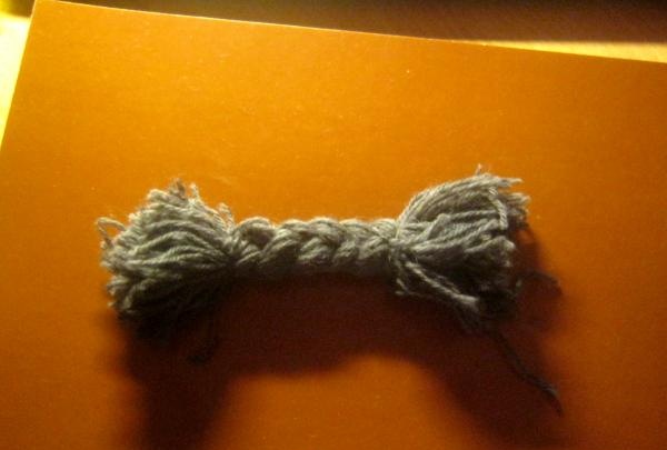 Doll made of woolen threads