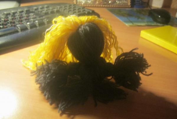 Doll made of woolen threads