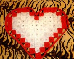 Knitted rug in the shape of a heart