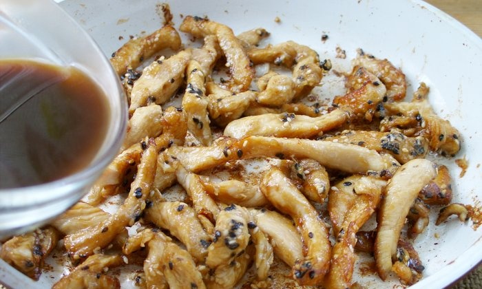 Chicken fillet in soy sauce in a frying pan