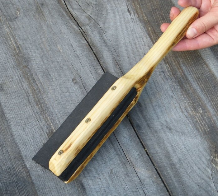 A homemade brush made from recycled materials that doesn't allow debris to stick to it.