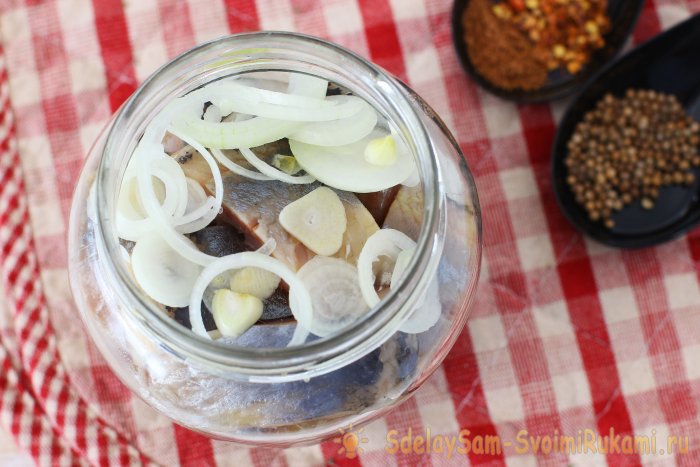 Herring marinated in a jar with spices and lemon