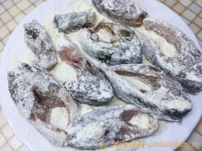 Fried crucian carp pieces in a frying pan