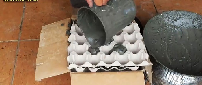Pot de fleurs en ciment et plateaux à œufs