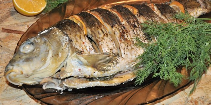 Whole carp with lemon and onion in the oven