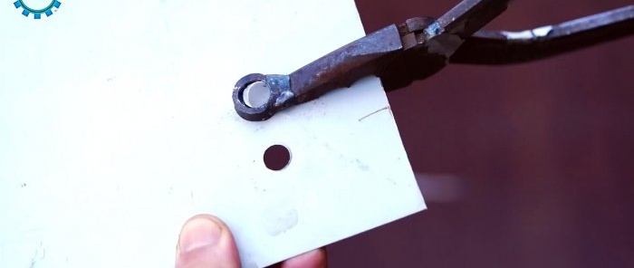 Manual hole punch for tin from broken pliers