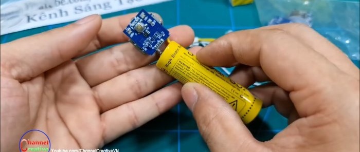 A power bank module with an LED is soldered to the battery