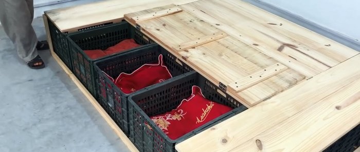 Bed made of plastic vegetable crates with numerous storage spaces