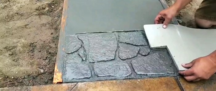 Hoe een betonnen tuinpad met imitatiesteen te storten