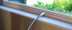 How to run a TV cable from the street through a window without drilling